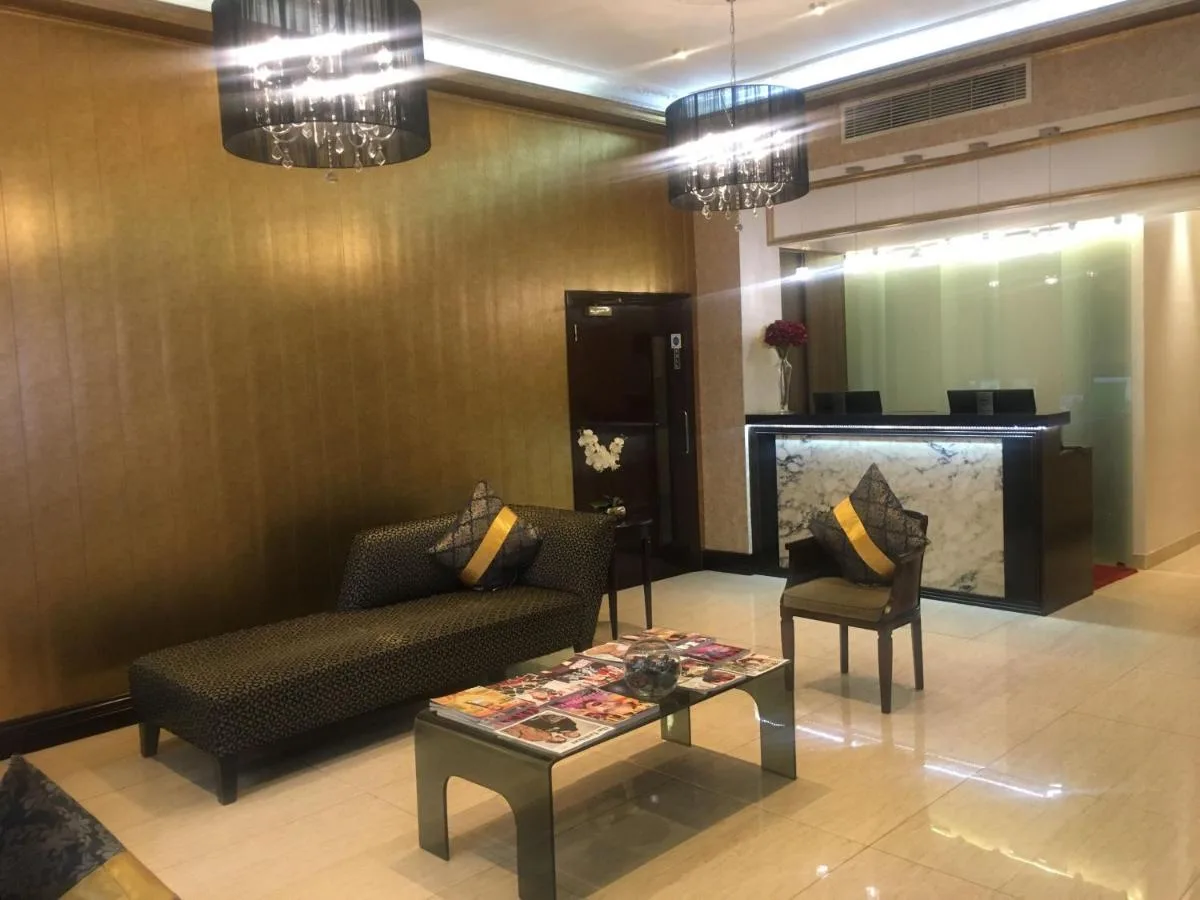 a lobby with a couch and two chairs and a table at The Premier Notting Hill in London
