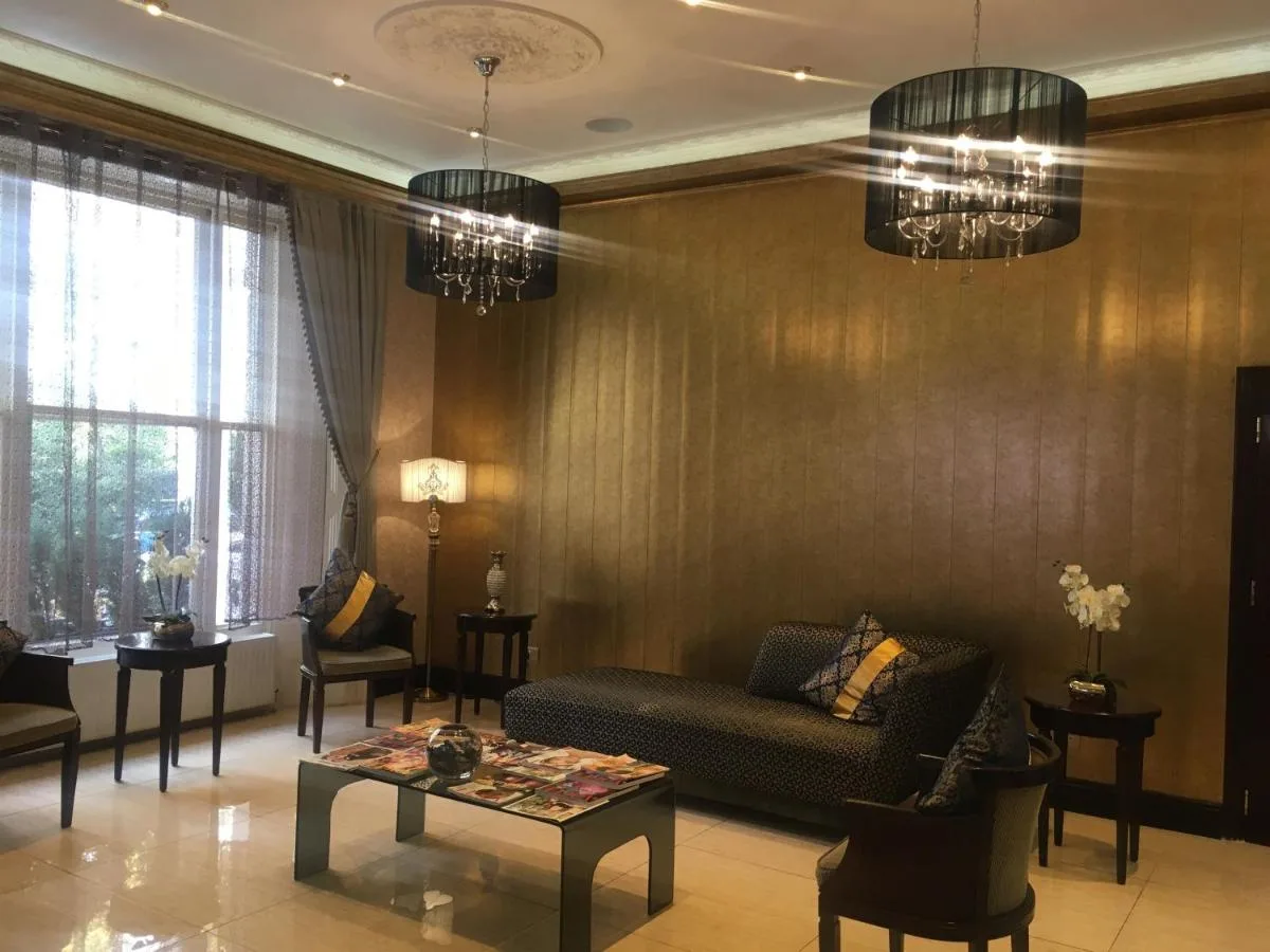 a living room with a couch and a table at The Premier Notting Hill in London