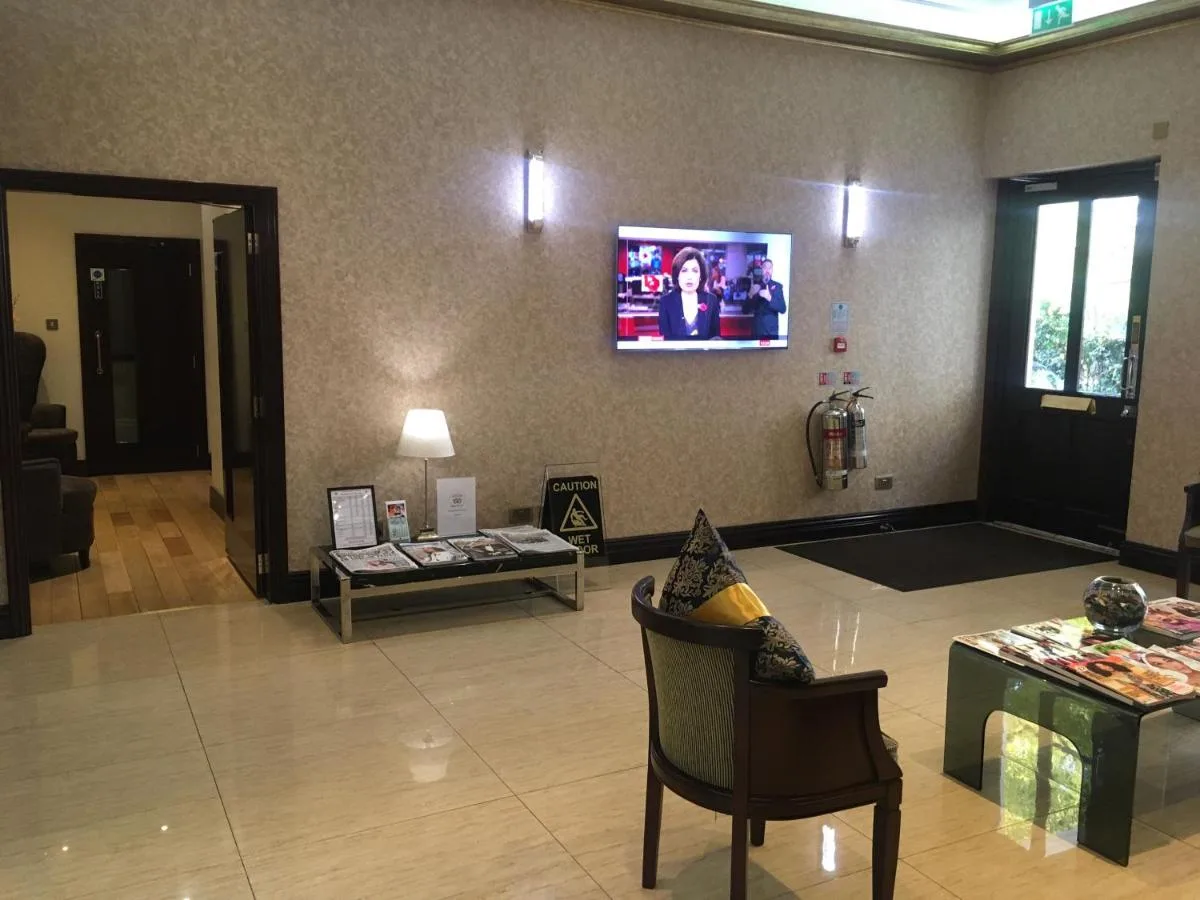 a living room with a tv on the wall at The Premier Notting Hill in London